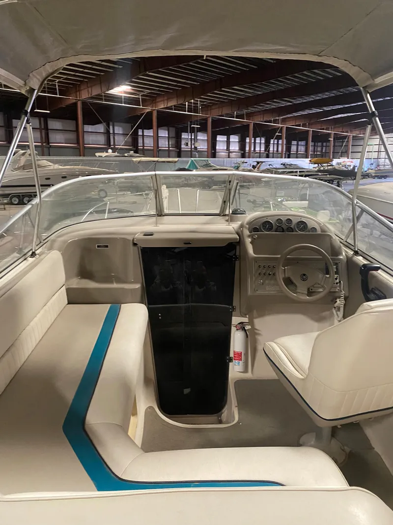Slide: The Image of 1995 Bayliner Ciera boat interior with seating and steering wheel in a storage facility. - 3
