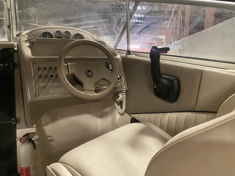Slide: The Image of 1995 Bayliner Ciera boat cockpit with steering wheel and control panel. - 4