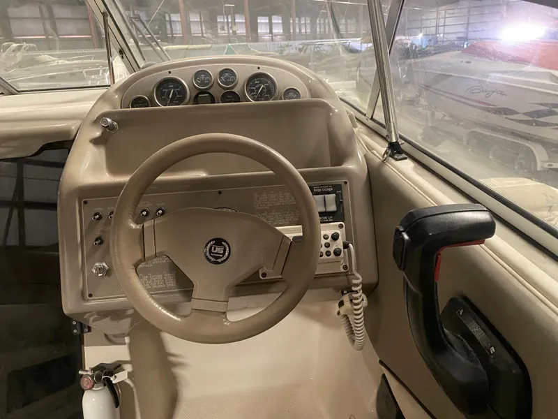 Slide: The Image of 1995 Bayliner Ciera boat helm with steering wheel and control panel. - 5