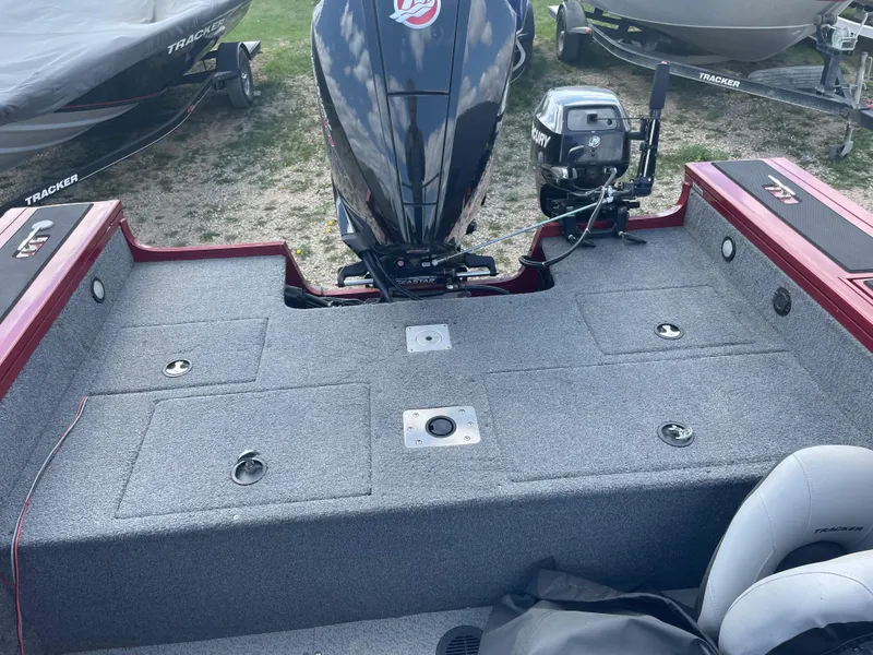 Slide: The Image of 2019 Tracker Targa 18 WT boat interior with gray seats and red trim. - 10