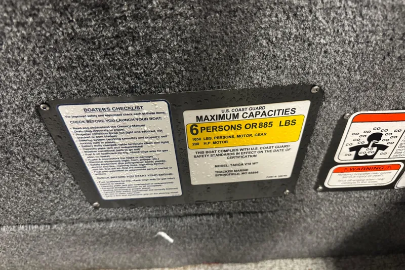 Slide: The Image of 2019 Tracker Targa 18 WT capacity and safety labels, including maximum weight and passenger limits. - 15