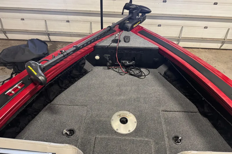 Slide: The Image of 2019 Tracker Targa 18 WT boat interior with trolling motor and carpeted deck. - 16