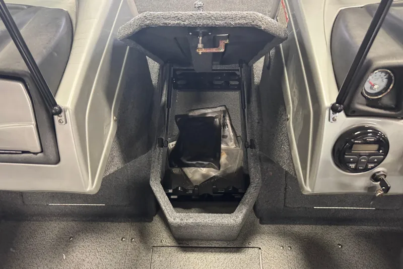 Slide: The Image of 2019 Tracker Targa 18 WT boat interior with open storage compartment. - 18
