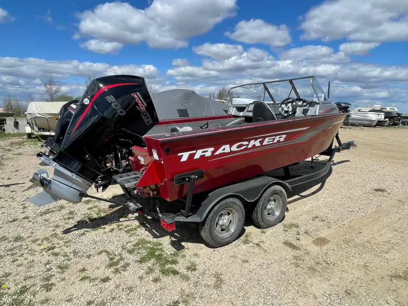 Slide: The Image of 2019 Tracker Targa 18 WT boat on trailer in indoor storage. - 2