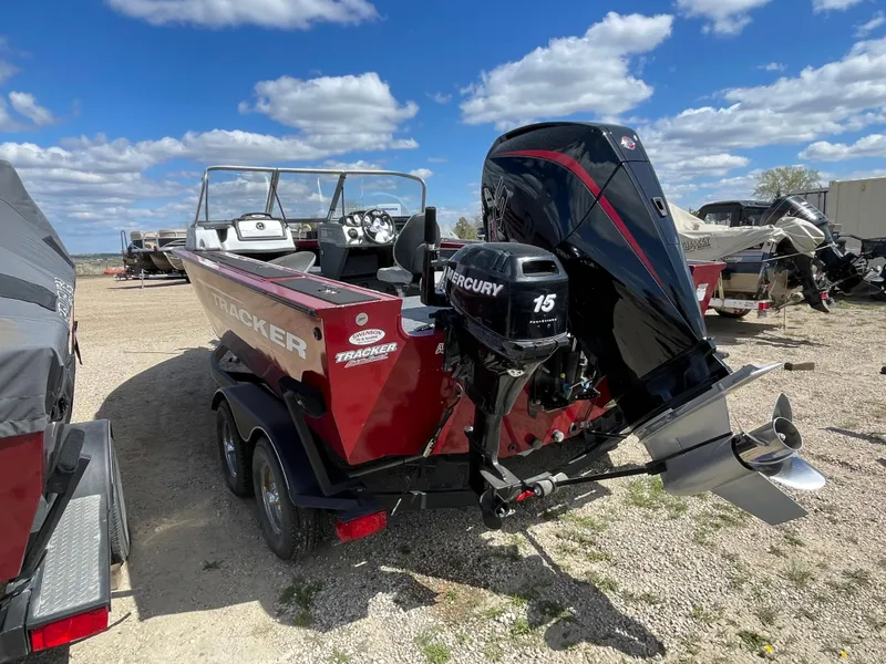 Slide: The Image of 2019 Tracker Targa 18 WT boat in garage, featuring powerful outboard motor. - 3