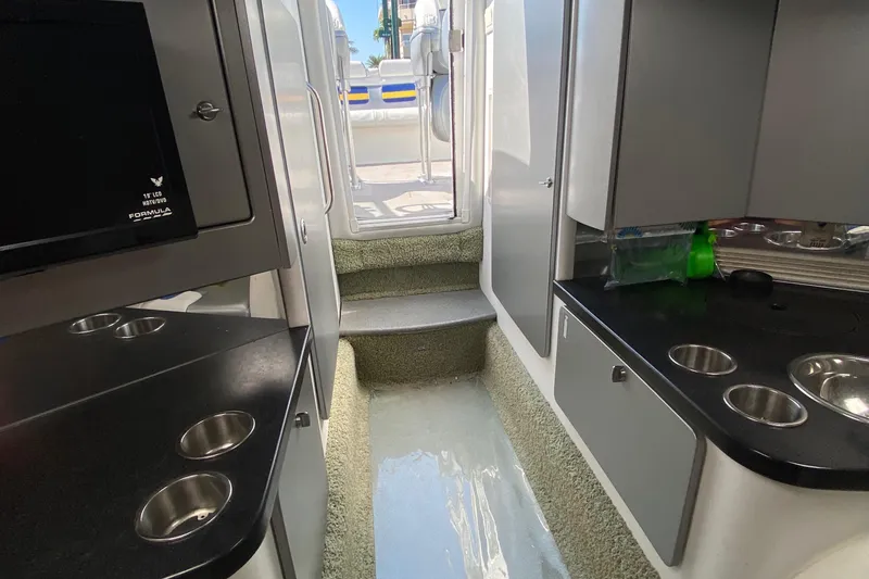 Slide: The Image of Interior of a 2013 Formula 382 FASTech boat with modern amenities and sleek design. - 15