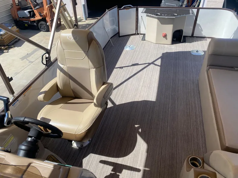 Slide: The Image of Luxurious 2019 Veranda VF25F2 pontoon boat interior with plush seating and cup holders. - 11