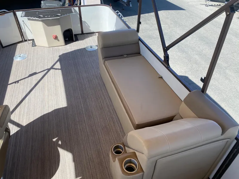 Slide: The Image of 2019 Veranda VF25F2 pontoon boat interior with beige seating and cup holders. - 12