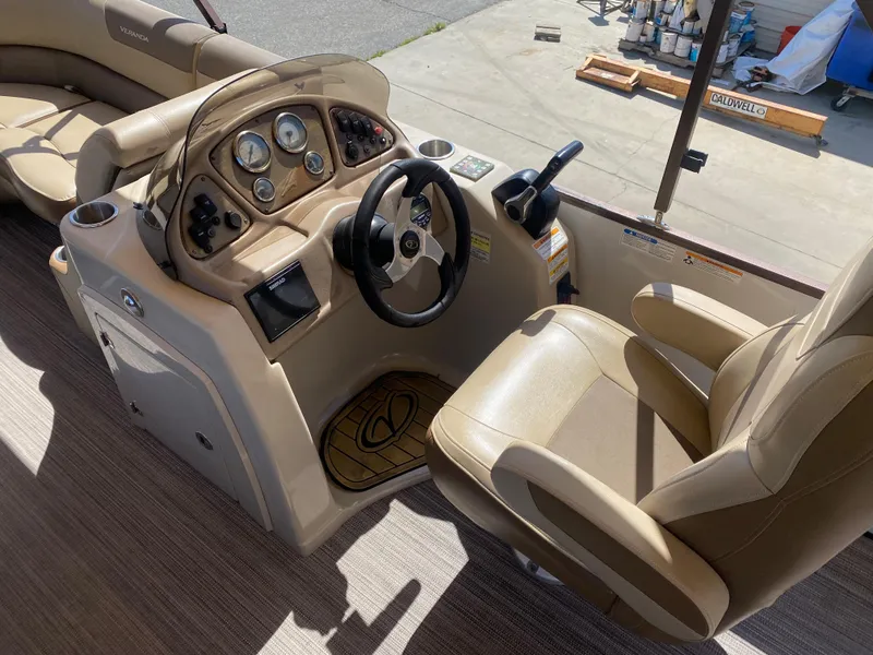 Slide: The Image of 2019 Veranda VF25F2 boat interior with tan leather seating and cup holders. - 14