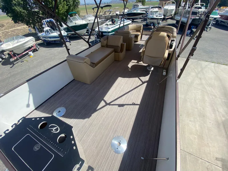 Slide: The Image of 2019 Veranda VF25F2 boat interior with beige seating and safety gate. - 18