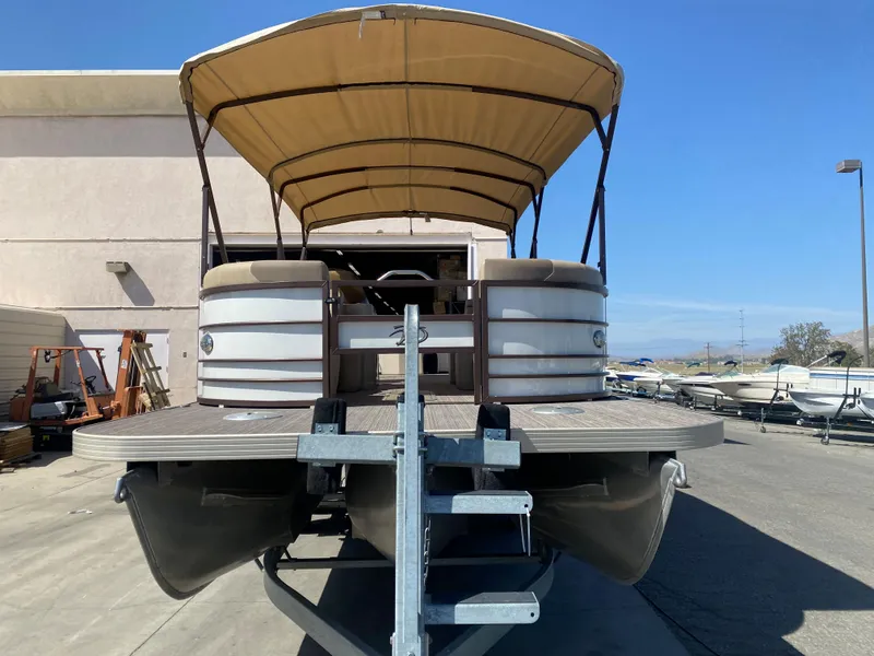 Slide: The Image of 2019 Veranda VF25F2 pontoon boat with canopy, parked near mountains. - 2