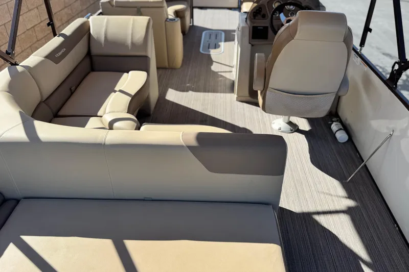 Slide: The Image of 2019 Veranda VF25F2 boat interior with beige seating and steering console. - 24