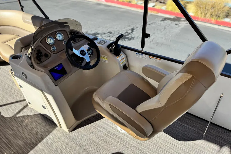 Slide: The Image of 2019 Veranda VF25F2 boat helm with steering wheel and beige captain's chair. - 25