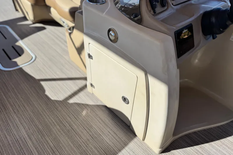 Slide: The Image of 2019 Veranda VF25F2 boat console with beige interior and storage compartment. - 27