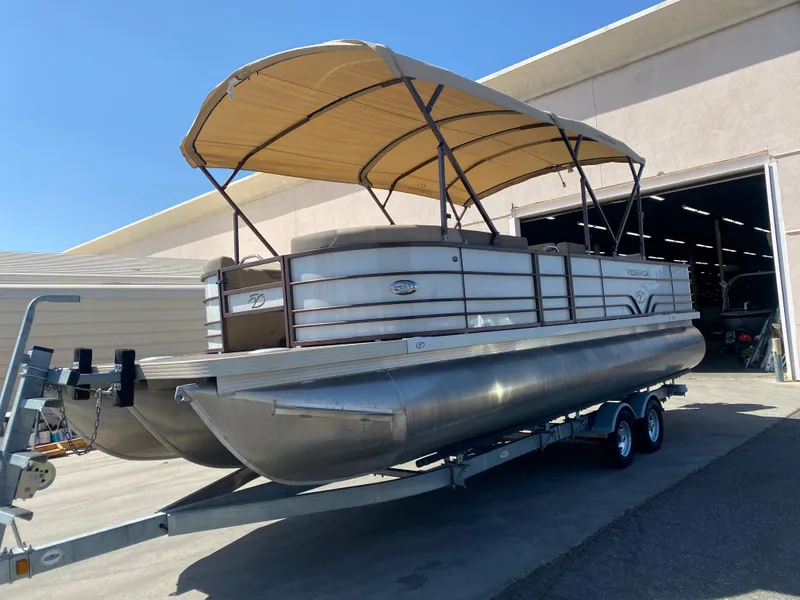 Slide: The Image of 2019 Veranda VF25F2 pontoon boat with canopy on trailer, outdoor setting. - 3