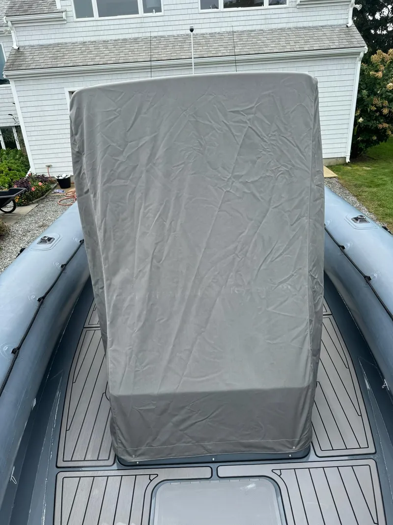 Slide: The Image of 2019 Sealegs 9M boat with covered console, docked near a house. - 10