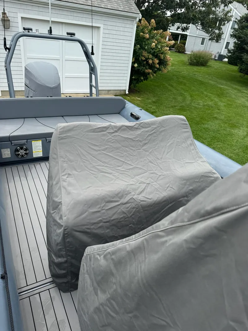Slide: The Image of 2019 Sealegs 9M boat with covered seats, parked near a garage. - 11