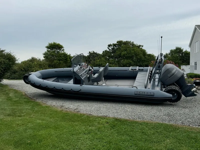 Slide: The Image of 2019 Sealegs 9M amphibious boat parked on gravel near grass and trees. - 12