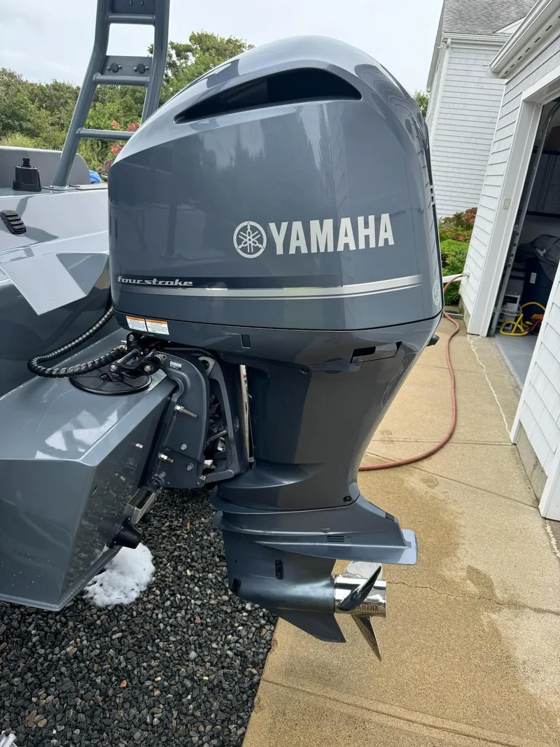 Slide: The Image of Yamaha outboard motor on 2019 Sealegs 9M boat, parked near a garage. - 16