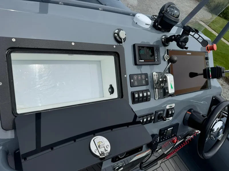 Slide: The Image of 2019 Sealegs 9M boat dashboard with navigation controls and display screens. - 18