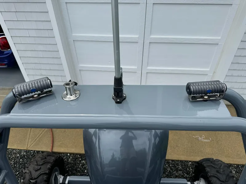 Slide: The Image of Sealegs 9M 2019 model with mounted equipment and rugged wheels, parked near a garage. - 22