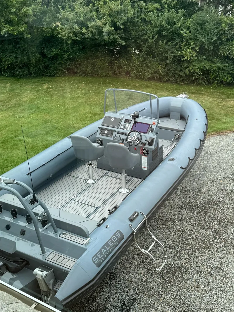 Slide: The Image of 2019 Sealegs 9M amphibious boat on gravel near grass, featuring advanced navigation controls. - 3