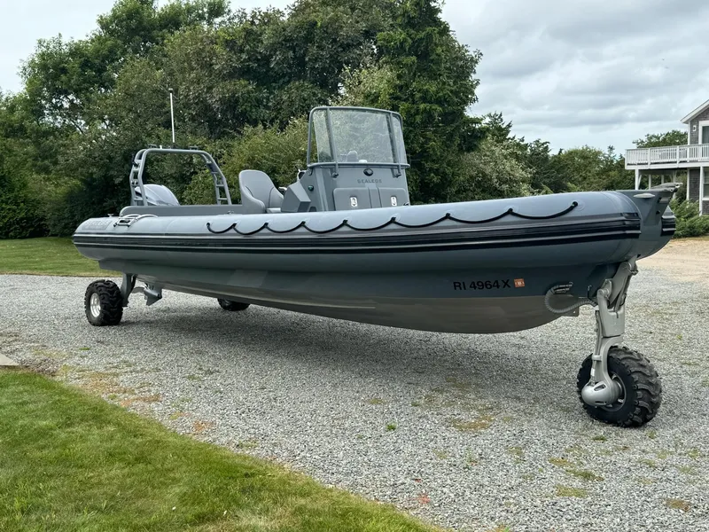 Slide: The Image of 2019 Sealegs 9M amphibious boat on land with wheels, surrounded by greenery. - 5