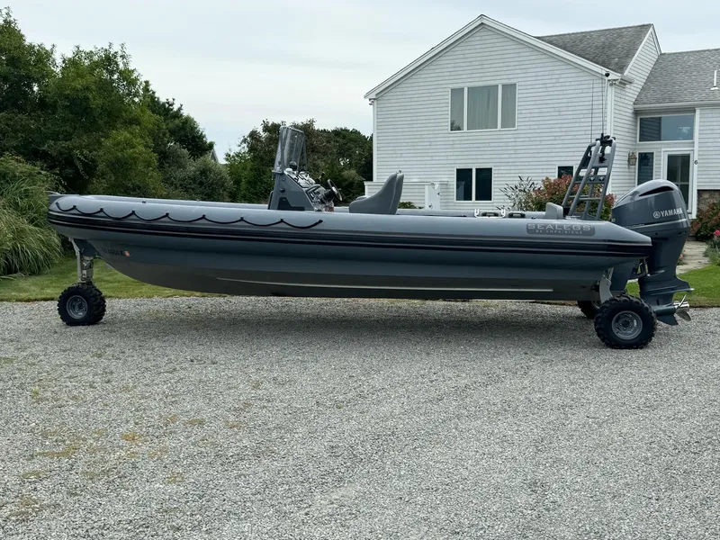 Slide: The Image of 2019 Sealegs 9M amphibious boat parked on gravel driveway near house. - 6
