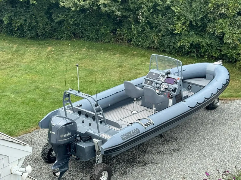 Slide: The Image of 2019 Sealegs 9M amphibious boat with Yamaha engine on gravel driveway. - 9