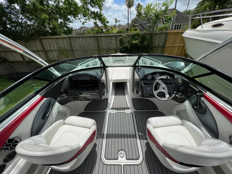 Slide: The Image of 2015 Monterey 224FSX boat interior with white seats and modern dashboard. - 16