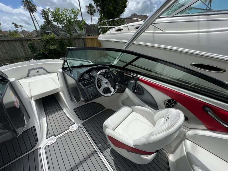 Slide: The Image of 2015 Monterey 224FSX boat interior with steering wheel and seating. - 18