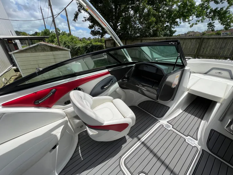 Slide: The Image of 2015 Monterey 224FSX boat interior with white and red seating, gray flooring. - 19
