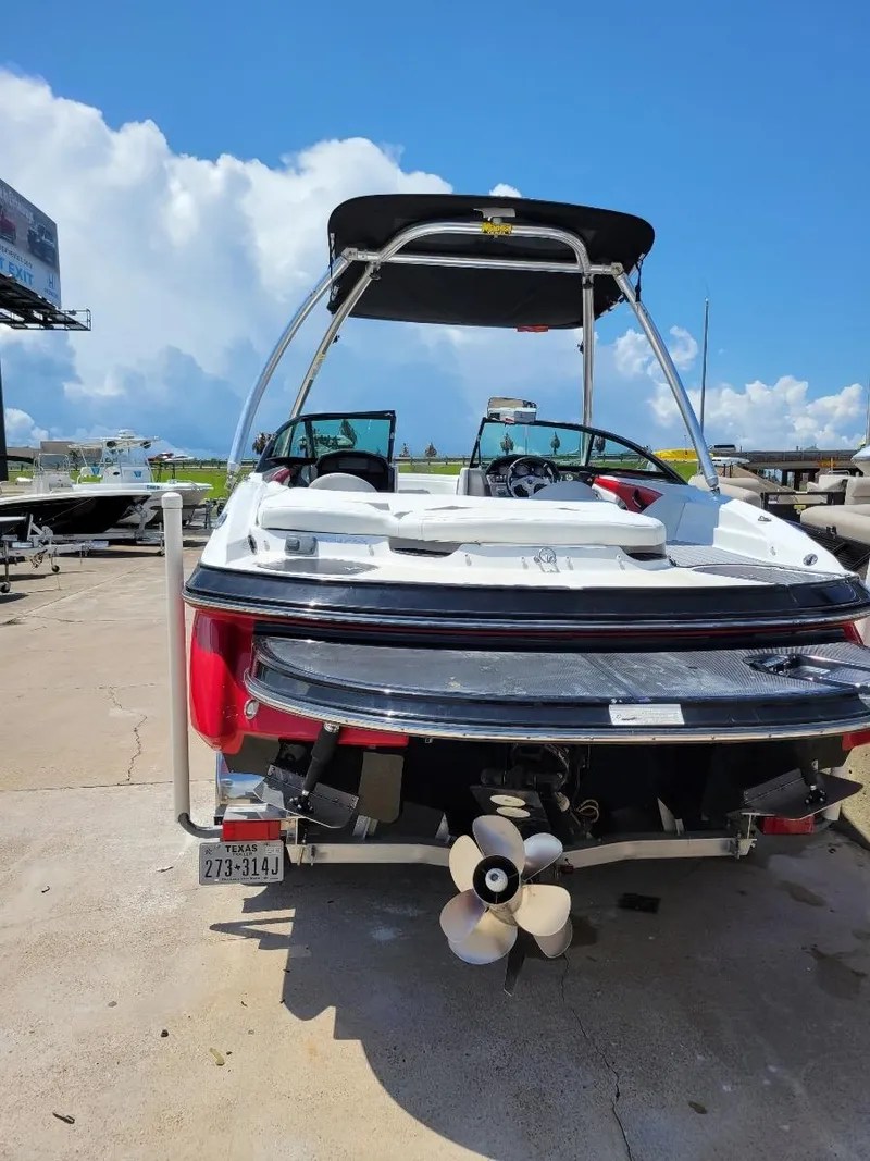 Slide: The Image of 2015 Monterey 224FSX boat docked, rear view with propeller and swim platform. - 2