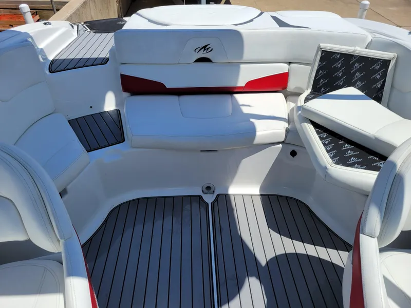 Slide: The Image of 2015 Monterey 224FSX boat interior with white and red seating. - 36