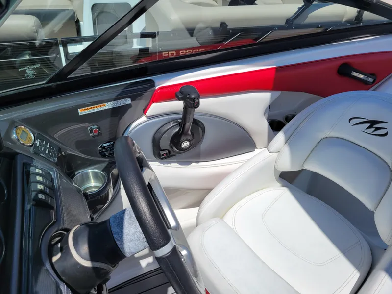 Slide: The Image of 2015 Monterey 224FSX boat interior with steering wheel and control panel. - 37