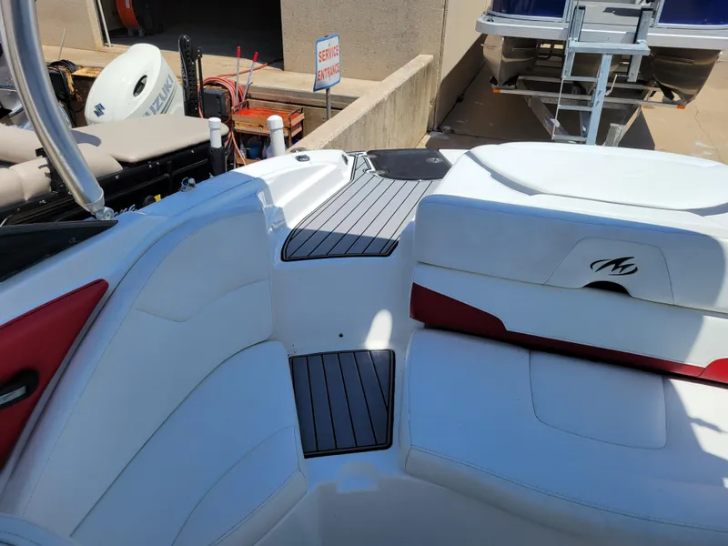 Slide: The Image of 2015 Monterey 224FSX boat interior with white and red seating. - 38