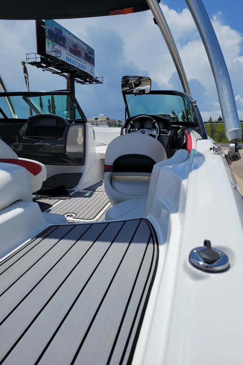 Slide: The Image of 2015 Monterey 224FSX boat interior with modern seating and steering wheel. - 40