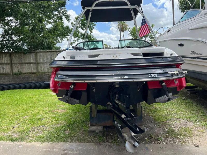 Slide: The Image of 2015 Monterey 224FSX boat on a trailer, rear view with American flag. - 8