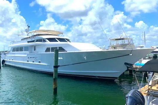 The Image of Luxury 1990 Broward Raised Pilothouse MY yacht docked under a bright blue sky. - 0