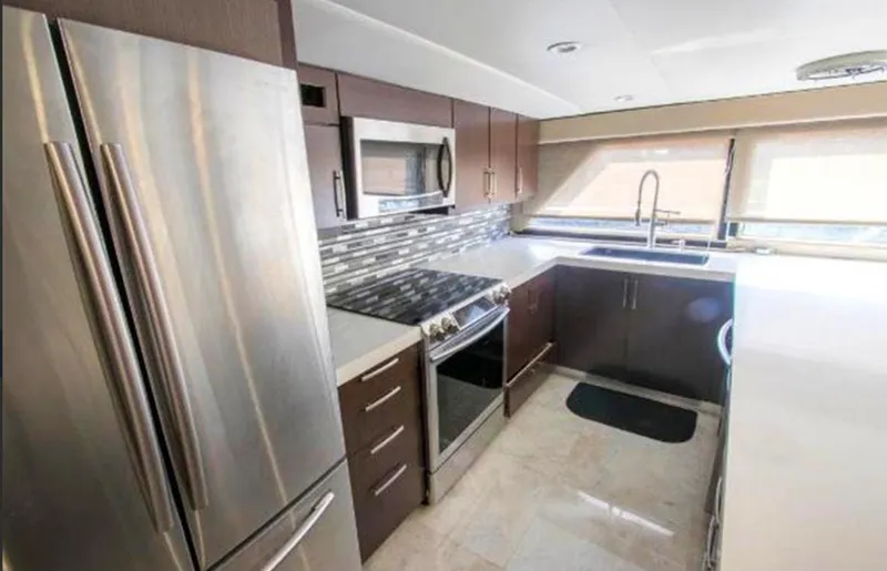 Slide: The Image of Modern kitchen interior on 1990 Broward Raised Pilothouse MY yacht, featuring stainless steel appliances. - 15