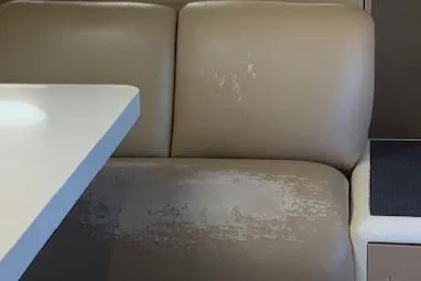 Slide: The Image of Worn beige seating in 1990 Broward Raised Pilothouse MY yacht interior. - 18