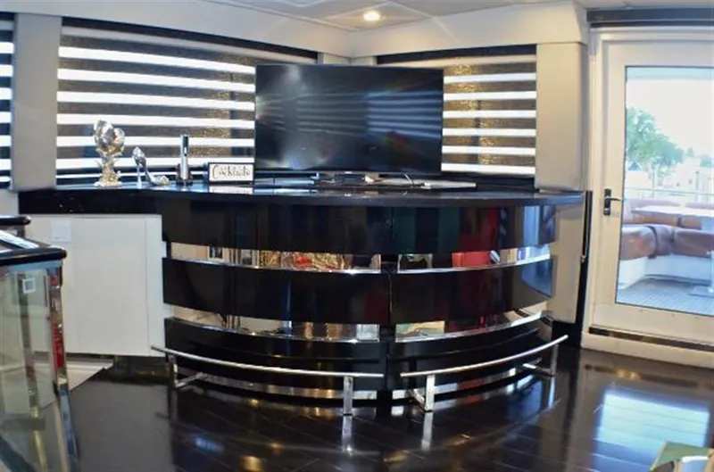 Slide: The Image of Luxurious interior of 1990 Broward Raised Pilothouse MY yacht with modern bar and TV setup. - 20