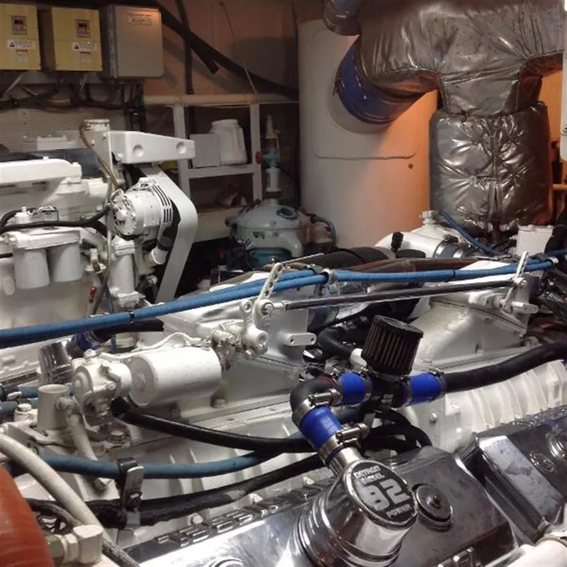 Slide: The Image of Engine room of 1990 Broward Raised Pilothouse MY yacht, showcasing mechanical components and piping. - 21