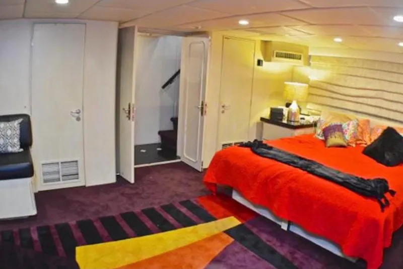 Slide: The Image of Luxurious bedroom in 1990 Broward Raised Pilothouse MY yacht with vibrant decor and modern amenities. - 23
