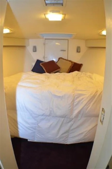Slide: The Image of Cozy bedroom in 1990 Broward Raised Pilothouse MY yacht with plush bedding and pillows. - 26