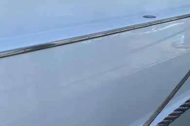 Slide: The Image of Side view of 1990 Broward Raised Pilothouse MY yacht with sleek white exterior. - 35