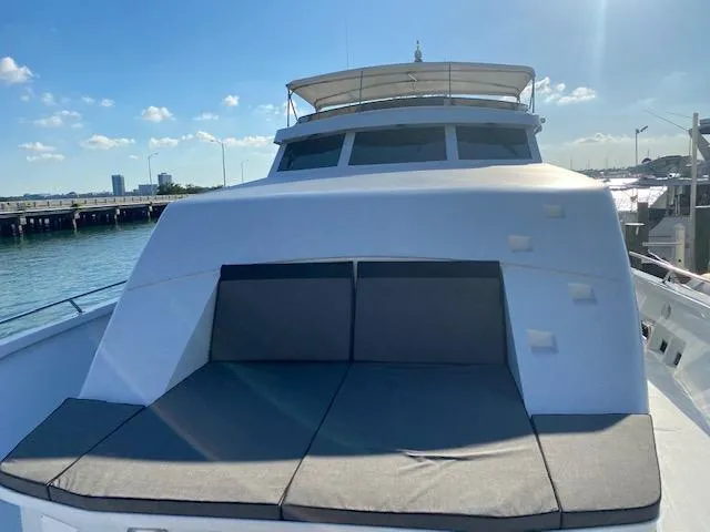 Slide: The Image of 1990 Broward Raised Pilothouse MY yacht with sun deck, docked by the water. - 9