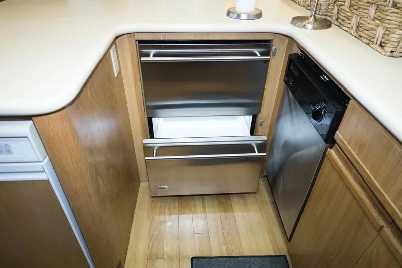 Slide: The Image of Modern kitchen area in a 1997 Hatteras 65 Convertible yacht with stainless steel appliances. - 10