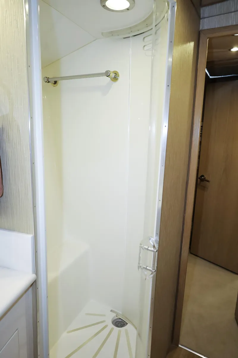 Slide: The Image of Shower area in 1997 Hatteras 65 Convertible yacht, featuring sleek design and modern fixtures. - 23