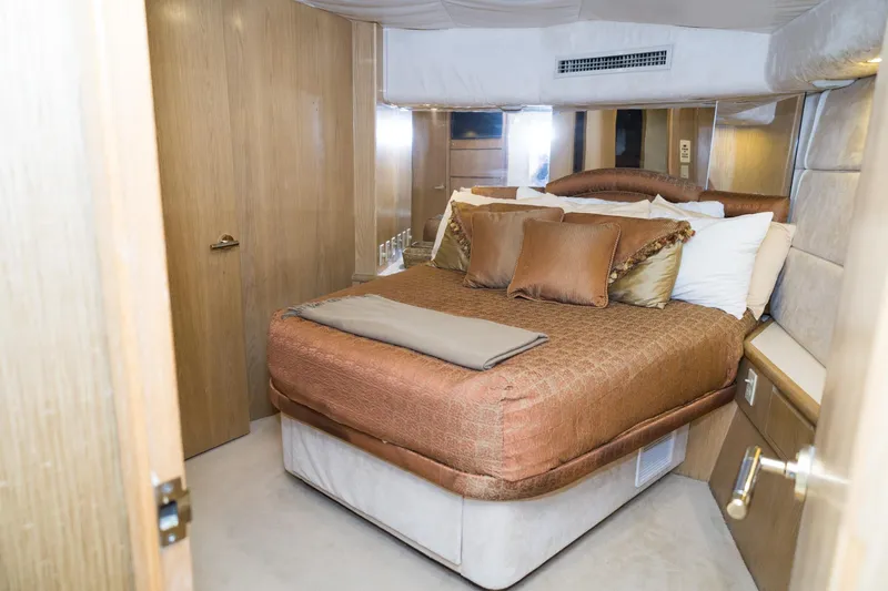 Slide: The Image of Luxurious bedroom interior of 1997 Hatteras 65 Convertible yacht with elegant bedding. - 28
